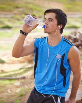 Theres nothing like fresh air and exercise. Shot of a handsome young man exercising outdoors.