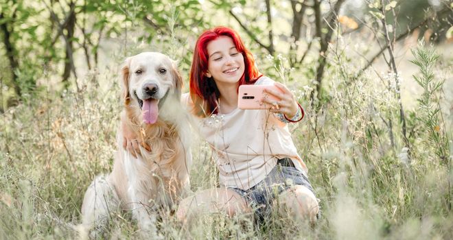 Teen girl with golden retriever dog