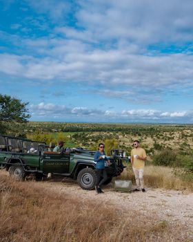 South Africa, luxury safari car during game drive, couple men and woman on safari in South Africa