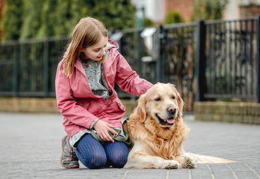 Girl and golden retriever dog