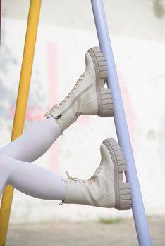 Female legs wearing white fashion boots with laces