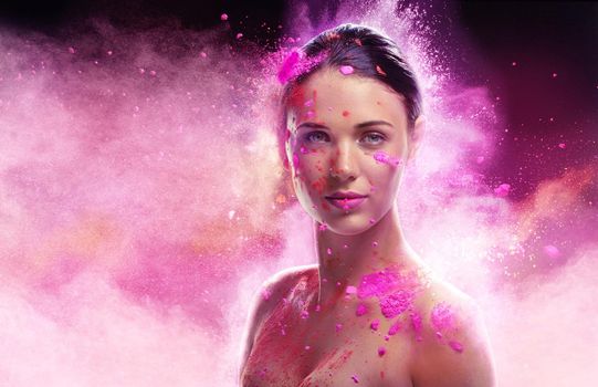 Ethereal beauty. Conceptual shot of a beautiful young woman covered in multi-colored powder paint.