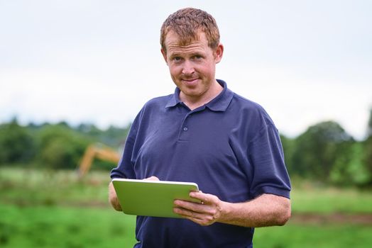 Making farming easier with modern tech. Shot of a farmer using a digital tablet on his farm.