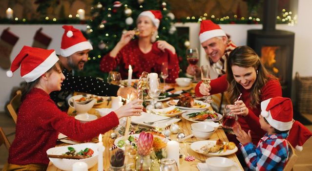 A fun Christmas packed with special family memories. Shot of a happy family having Christmas lunch together at home.