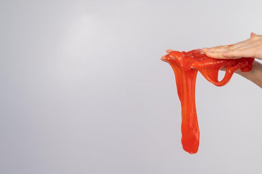 Red slime flowing down from a woman's hand on a white background.