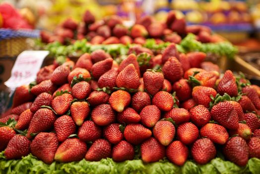 A display of delicious red strawberries at a food market.