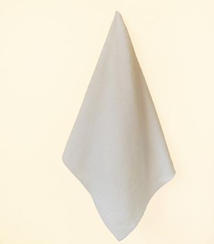 White Spa towel hanging on a yellow wall