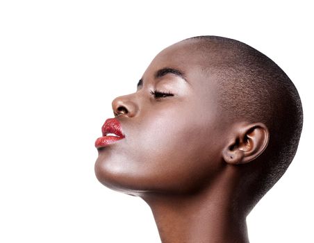 Make up is self-confidence applied directly to the face. Studio shot of a beautiful young african woman wearing red lipstick isolated on white.