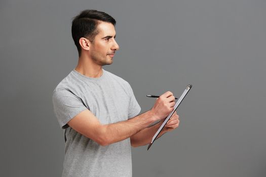 portrait man folder for papers holding a pen posing lifestyle cropped view. High quality photo