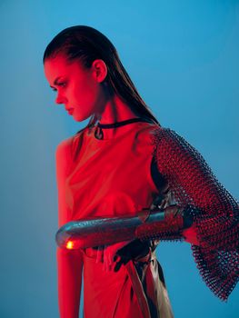 beautiful woman Glamor posing red light metal armor on hand Lifestyle unaltered. High quality photo