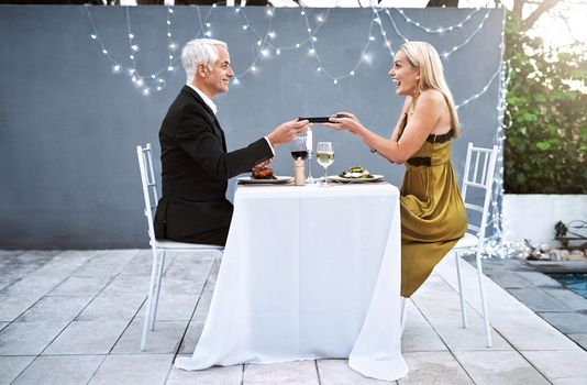 She loves it when I surprise her with unexpected gifts. Shot of a mature couple out on a romantic date.