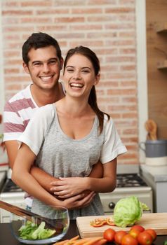 Their secret ingredient is love. Portrait of an attractive young couple bonding in the kitchen.