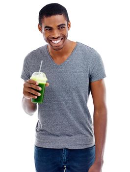 Green smoothie goodness. Studio shot of a handsome young man enjoying a fruit smoothie.