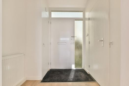 A narrow white corridor with carpet