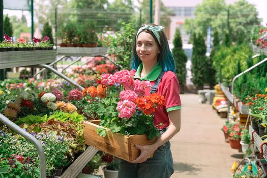 Florist working and arranging flower pots in garden store