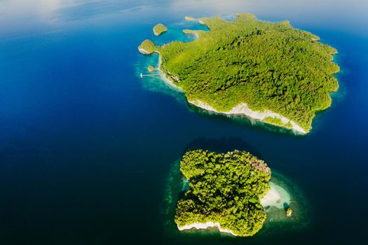 The ocean is full of islands. High angle shot of beautiful green islands in the ocean.