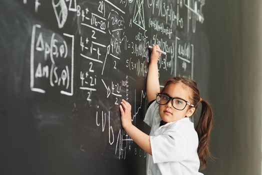 They make it just so easy for me. Shot of an academically gifted young girl solving a math equation.