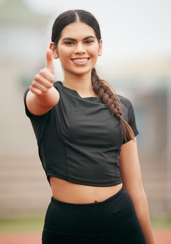 You can do anything you put your mind to. Shot of an athletic young woman showing thumbs up.