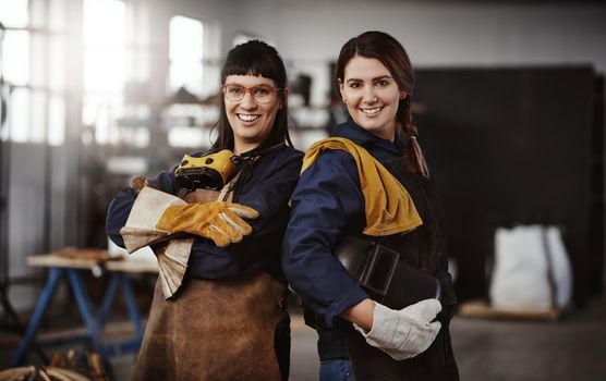 We create art from metal. Cropped portrait of two attractive young female artisans standing in their workshop.