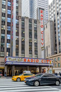 Radio City Music Hall New York City with crosswalk and traffic