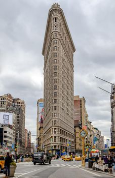 Flatiron Building New York City with street and yellow taxi cabs in forefront