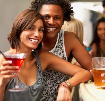 A cropped portrait of happy young people having drinks at a bar.