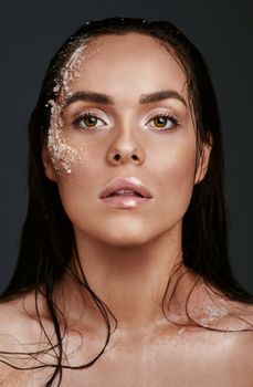 Exfoliating is what keep me shining like a diamond. Shot of a beautiful young woman posing with salt on her face.