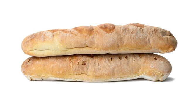 two baked baguettes made from white wheat flour on a white background