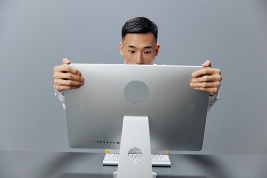 Asian man in a white shirt computer fatigue office technologies