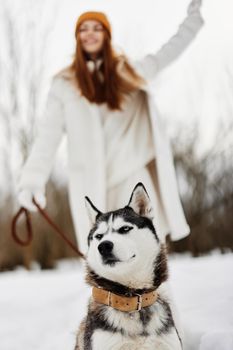 young woman with husky on the snow walk play rest winter holidays. High quality photo
