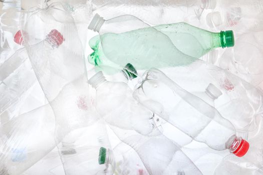 Empty plastic bottles background. Water PET bottle recycling plastic material recyclable waste sorting. Recyclable trash recycle garbage concept. Many bottles transparent plastic PET recycling waste