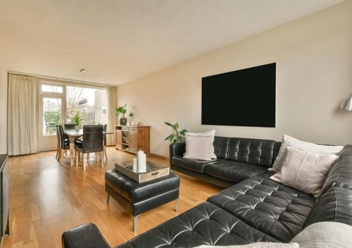 Spacious living room with black sofa
