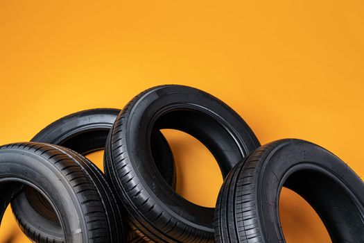 Car tires isolated on yellow background, close up