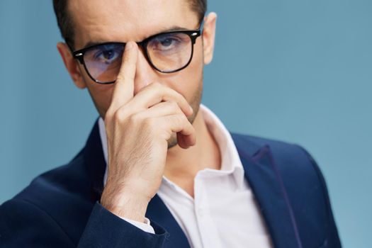 handsome man adjusts his glasses with his finger self-confidence close-up