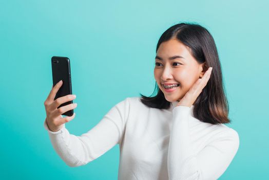 woman smile she using a smartphone to selfie photo