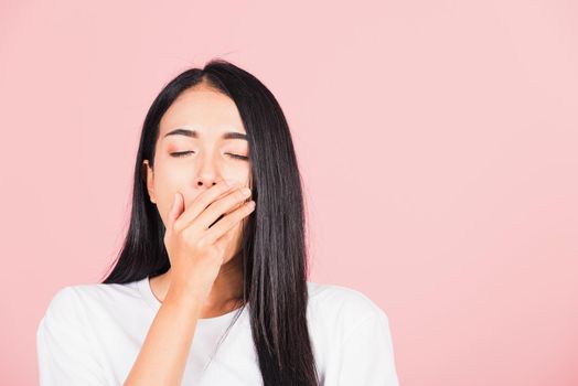 woman emotions tired and sleepy her yawning covering mouth open by hand