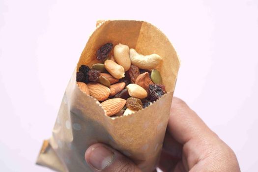 top view of many mixed nuts in a paper packet