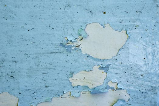 Old grunge blue wooden background with peeling paint, close up