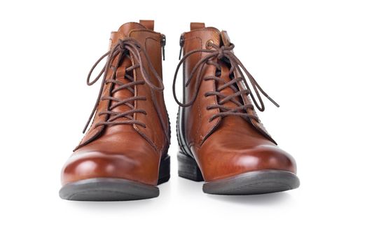Pair of brown leather womens boots on the white background isolated