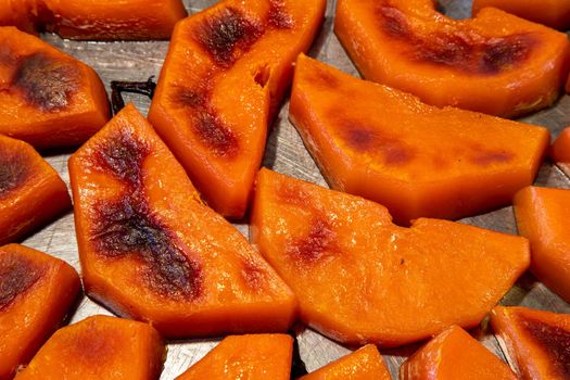 Freshly roasted pumpkin in small slices. View from above