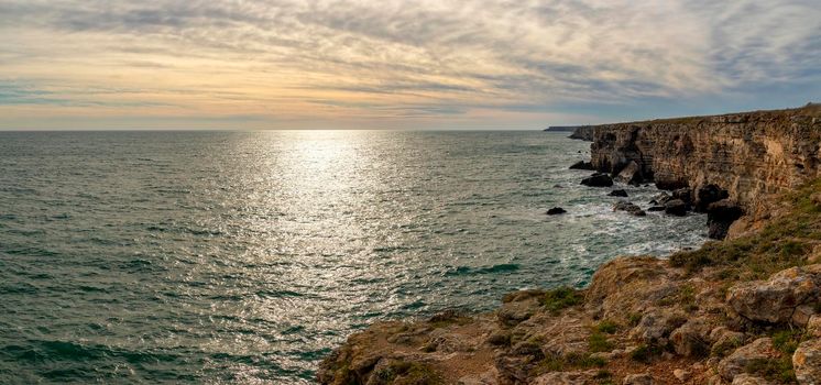 Panoramic seascape with scenic clouds over the sea with big rocks