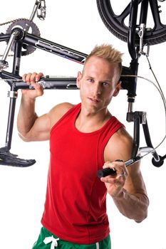 Fit strong sportsman lifting bicycle in white studio