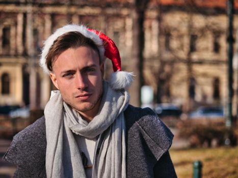 Young Handsome Man in Santa Claus Hat on Street