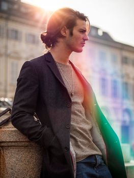 Elegant young man outdoor wearing wool coat
