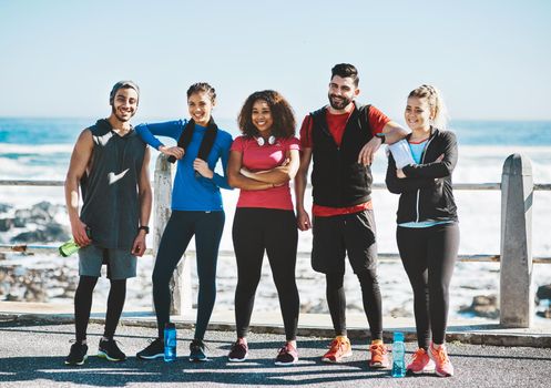 Our dedication is what keeps us together. Shot of a fitness group standing together while out for a run.