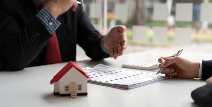 Real estate agent has proposed terms and conditions to customers who sign house purchase agreements with insurance, Agreement to sign the purchase contract concept.