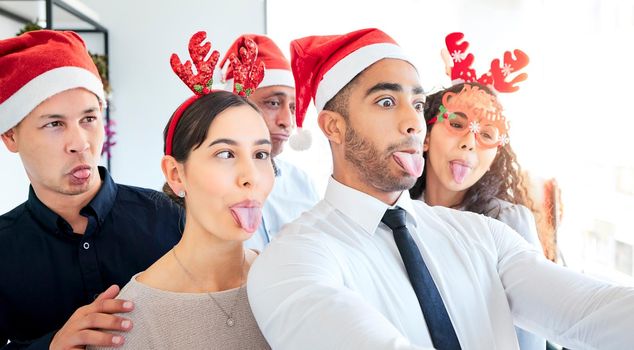 Is it silly season or Christmas season. Shot of a group of businesspeople taking a selfie at work.