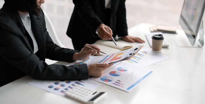 business people presentation data of financial or marketing figures, graphs and charts for reviewing market data and business strategy plan.