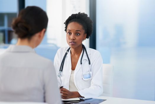 Any symptoms I should be aware of. Cropped shot of a female doctor talking to a patient in her office.