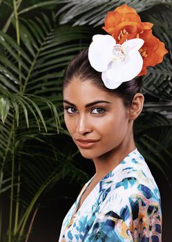 A rare and beautiful flower. A portrait of a beautiful woman wearing a floral headdress in a jungle.